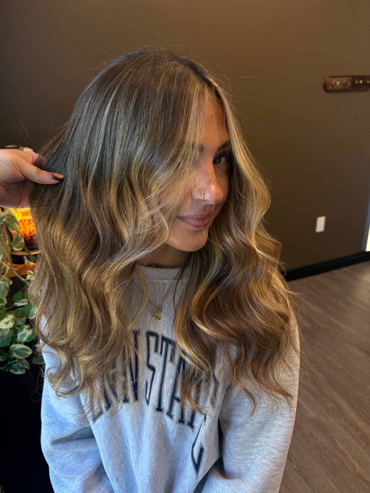 Long dimensional blonde with soft face framing by Hair by Maddie Rose